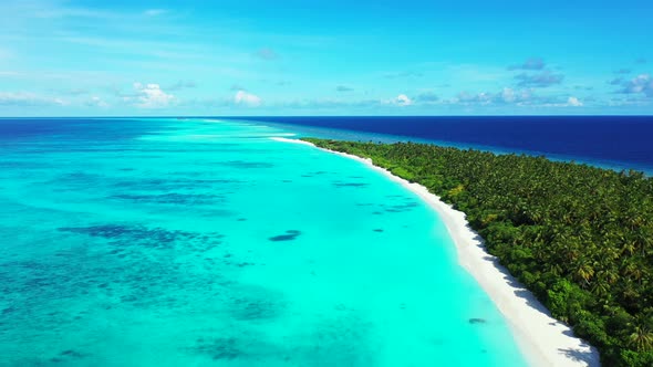 Wide birds eye abstract shot of a sandy white paradise beach and aqua blue ocean background in color alt
