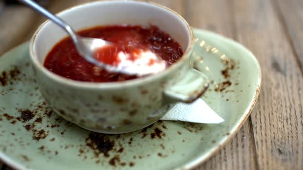 Borsch with sour cream served in cafe alt