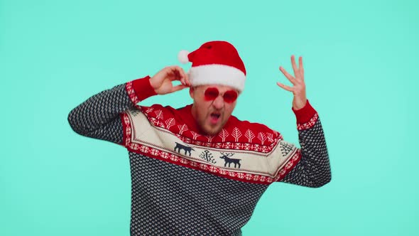 Man in Christmas Sweater Listening Music Via Earphones Dancing Disco Fooling Around Having Fun alt