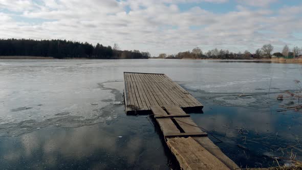 the Beginning of Spring. Jetty on the Lake in the Ice