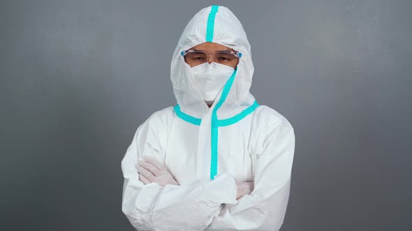 doctor man with crossed arms, wearing PPE suit against coronavirus(covid-19) pandemic