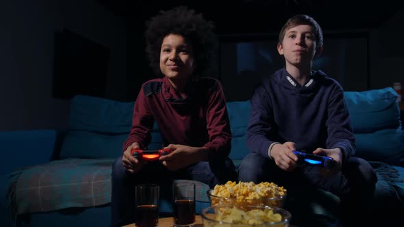Cute Boys Competing in Video Game on Home Console alt