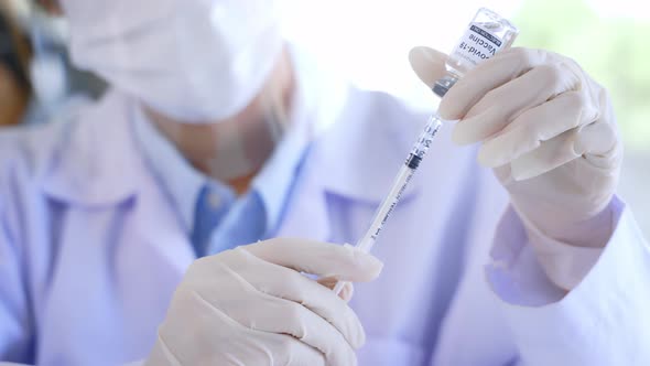 Medical Researcher and Scientist in Labcoat Working on Developing Covid19 Vaccine in Laboratory alt