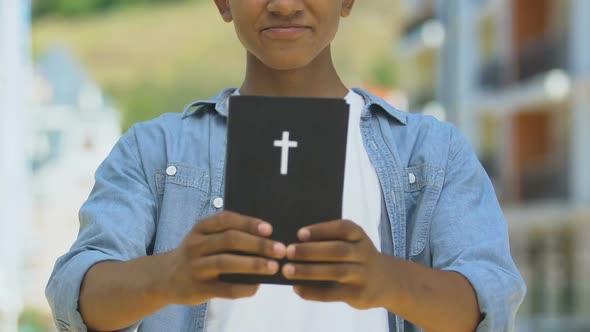 Teen Boy Holding Bible, Spiritual Development alt