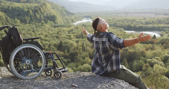 Invalid Which Sitting Near His Wheelchair on the Top of the Mount and Substituting His Face Under  alt