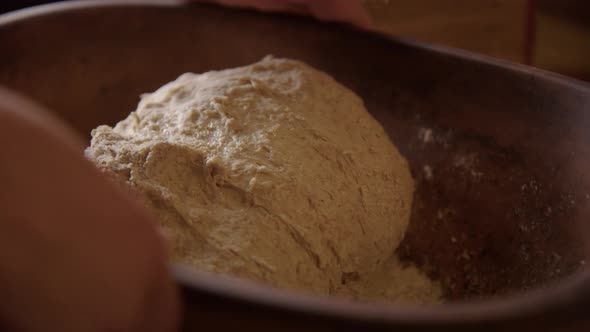 BAKING - Kneading sourdough bread dough, turning bowl, slow motion close up alt