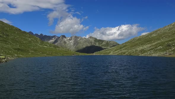 Timelapse view on peak of mountains and lake in Swiss Alps