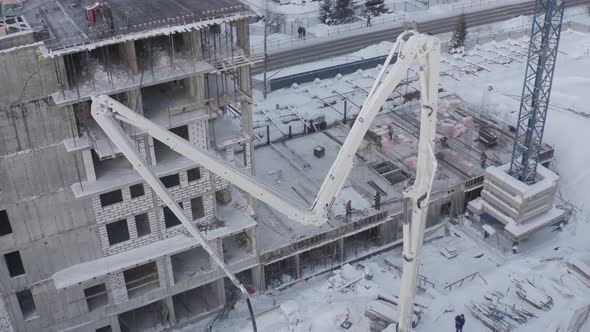 A Drone View of the Construction of a Residential Building Using a Concrete Pump alt