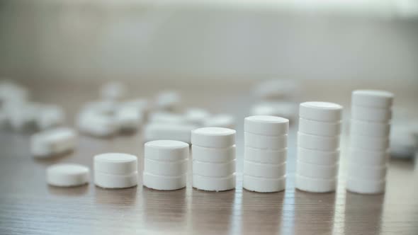 Columns of Tablets on the Table Close-up. The Concept of Increasing the Price of Medicines
