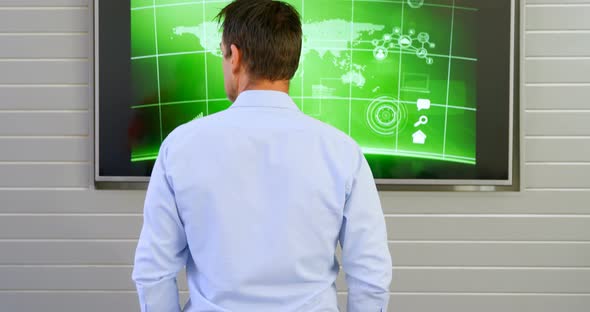 Executive looking at lcd screen in office  alt