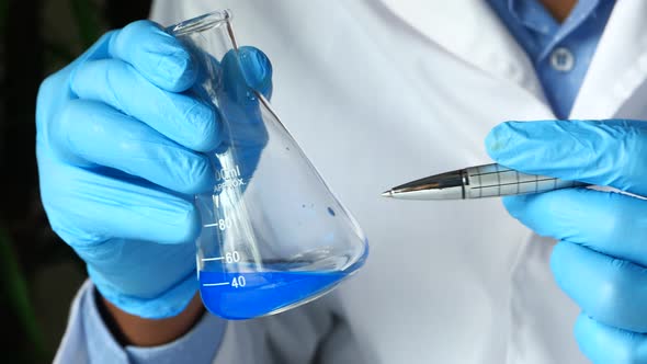 Hand of Scientist Holding Lab Glassware Close Up  alt