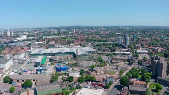 Dolly forward drone shot over industrial South East London on a sunny day alt