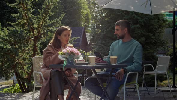 People Drink Coffee on the Outdoor Terrace