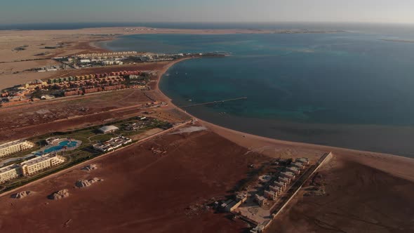 Evening flying from above over the hotel and the desert near Hurghada ...