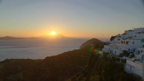 Aerial Pan of White Houses of Plaka Village in the Island of Milos at Sunset alt