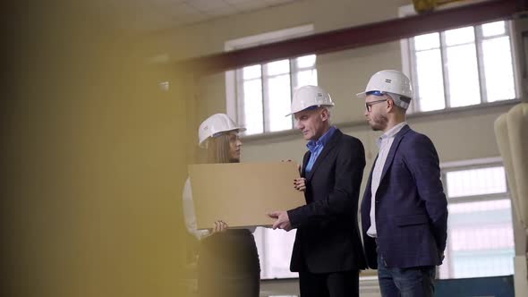 Young Female Executive Manager Providing Excursion for Inspection or Sponsors and Demonstrating alt