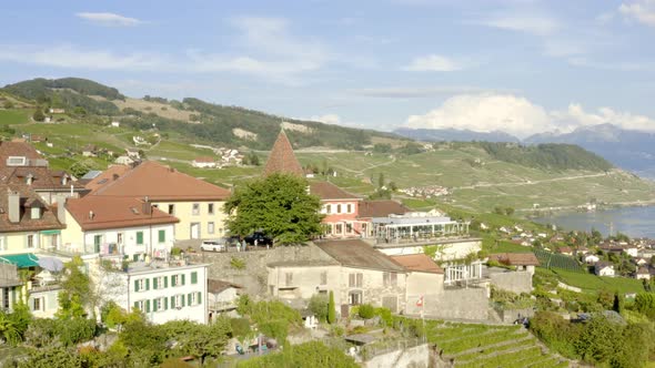 Low aerial orbit around typical Swiss village in Lavaux vineyard (Grandvaux, Lavaux - Switzerland)L alt