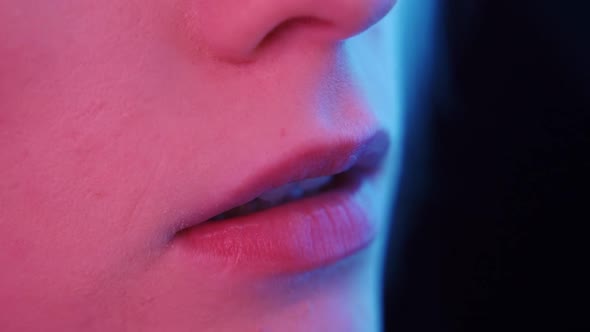 Beautiful Delicate Female Lips in Neon Light