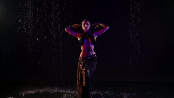 Eastern Dance of Young Woman Standing Under Rain in Darkness Arabic or Indian Belly Dance alt