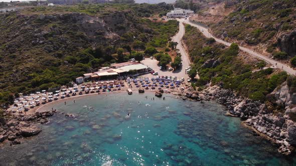 birds eye view rising up over anthony quinn bay in rhodes island showing the whole environment with alt