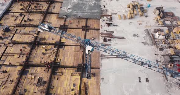 Flight Over the Construction Site of the Shopping Center, with Crane and Scaffolding. with People at