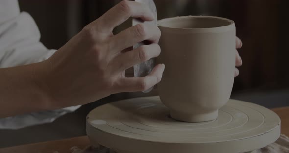 Professional Potter Working On A Cup