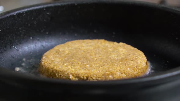 Cutlet in a Breading is Fried in a Pan Closeup