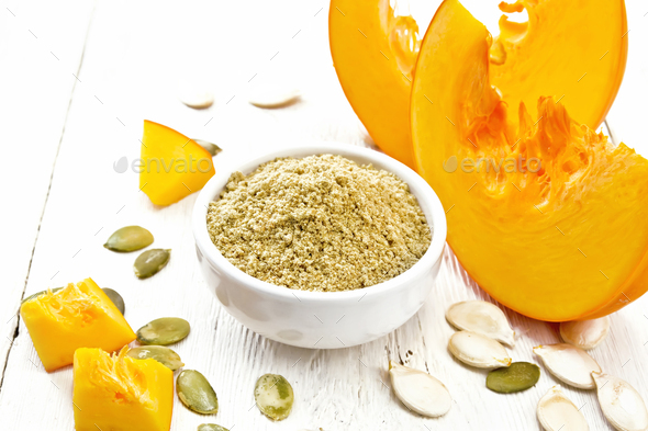 Flour pumpkin in white bowl on wooden board - Stock Photo - Images