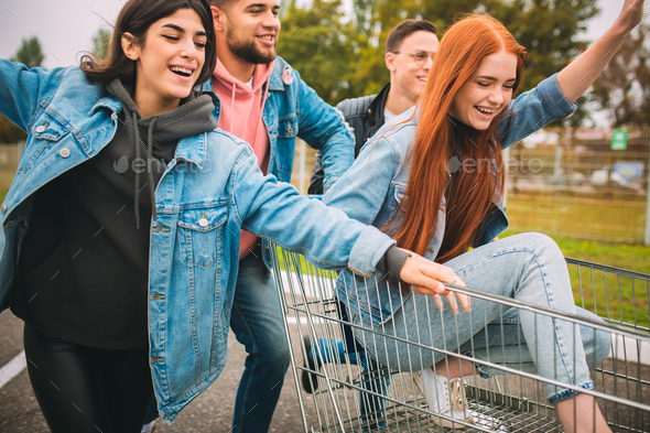 Group of four young diverse friends in jeanse outfit look carefree, young and happy on city\'s