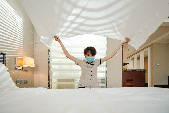 Hotel maid changing sheets