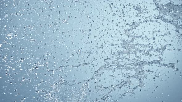 Super Slow Motion Shot of Side Water Splash on Blue Gradient Background at 1000Fps. alt