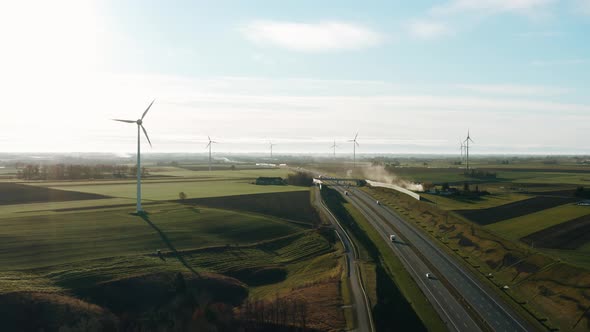 Aerial Drone View Windmills Wind Turbines Producing Clean Ecological Electricity By Road in Green alt