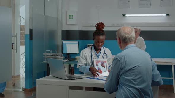 Woman with Doctor Occupation Holding Modern Tablet alt
