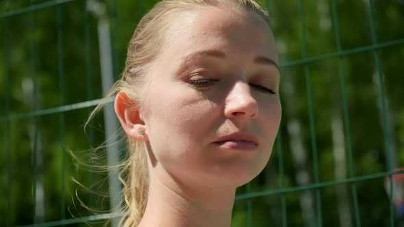 Closeup Portrait of Young Blond Caucasian Woman with Ponytail on Sunny Day