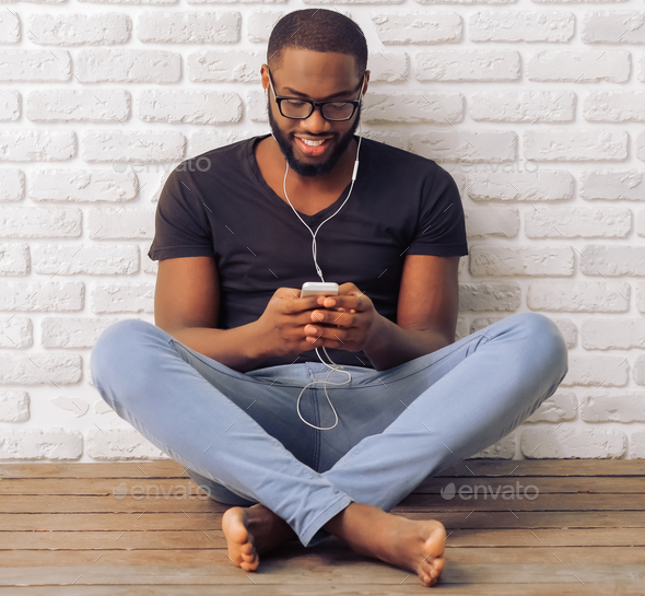 Afro American man with gadget - Stock Photo - Images