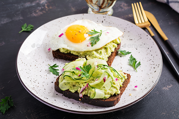 Healthy breakfast. Sandwich with avocado guacamole, cucumber and fried egg, for healthy breakfast or snack.