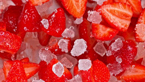 Super Slow Motion Shot of Fresh Strawberries and Crushed Ice Flying Towards Camera at 1000Fps alt