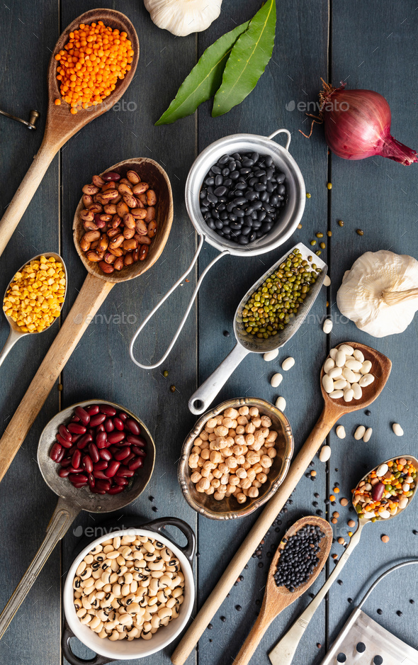 Top view flat lay of assortment of legumes on blue tabletop