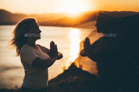 Woman practicing Yoga, meditation close to the sea. - Stock Photo - Images