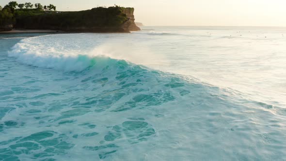 Moving over large waves at sunset