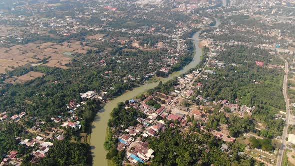 Aerial clip of the muddy waters of Sangkae River in Battambang Cambodia during a summer day alt