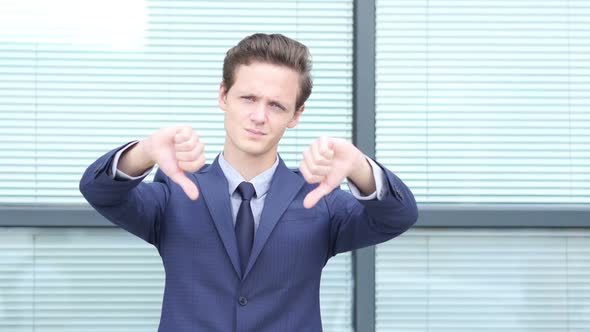 Thumbs Down by Young Businessman with Both Hands alt