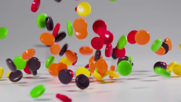 Colorful candy falls in slow motion alt