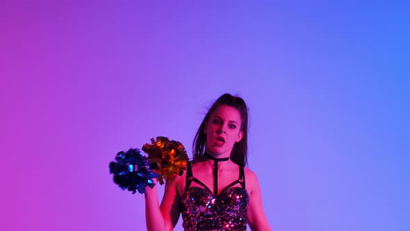 Energetic Cheering Dance Performed By Cute Cheerleader with Pompoms in Hands Against Blue Pink alt