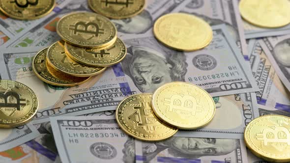 Rotating Bitcoin Coins Scattered Over US Dollar Banknotes Closeup alt