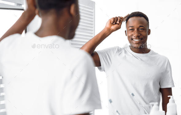 black man brushing hair