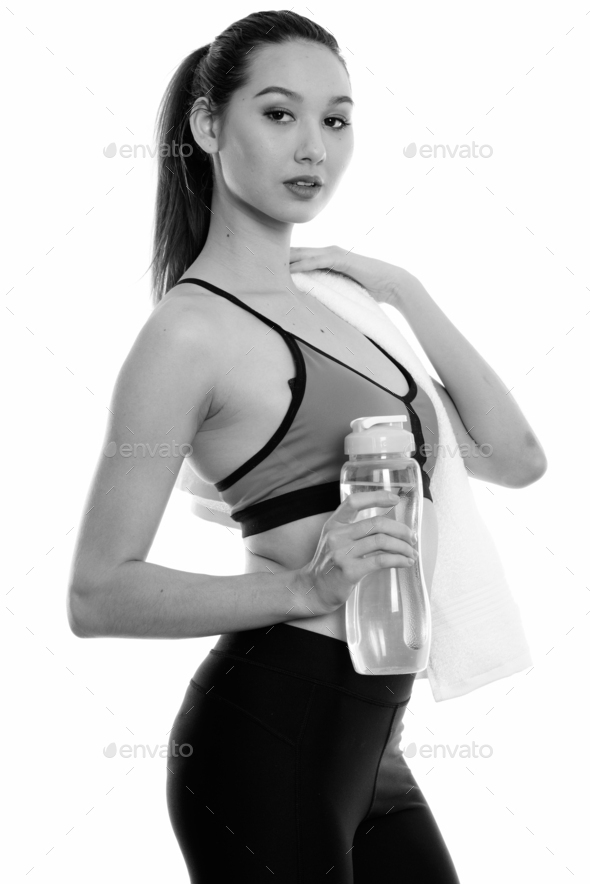 A woman in a sports bra holding a water bottle photo – After the