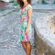Beautiful brunette middle-aged woman wearing spring colorful dress