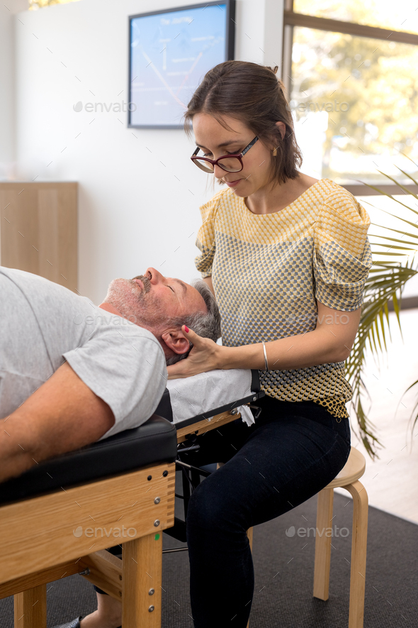 Senior man having chiropractic adjustment