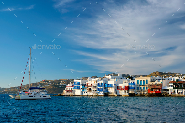 Sunset in Mykonos, Greece, with cruise ship and yachts in the harbor - Stock Photo - Images